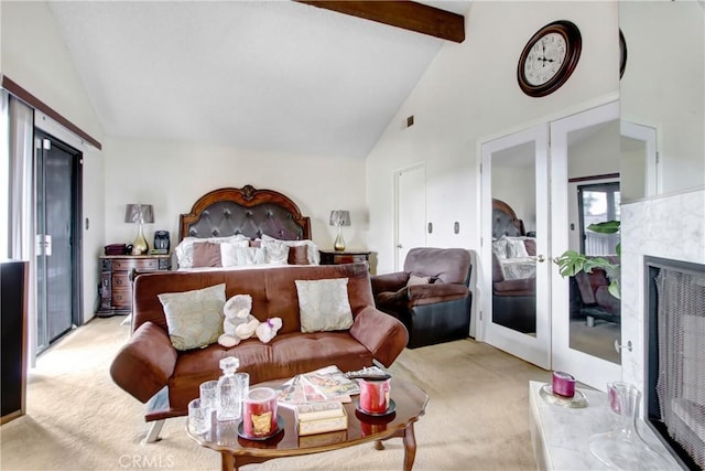 bedroom with high vaulted ceiling, light colored carpet, a premium fireplace, beam ceiling, and french doors