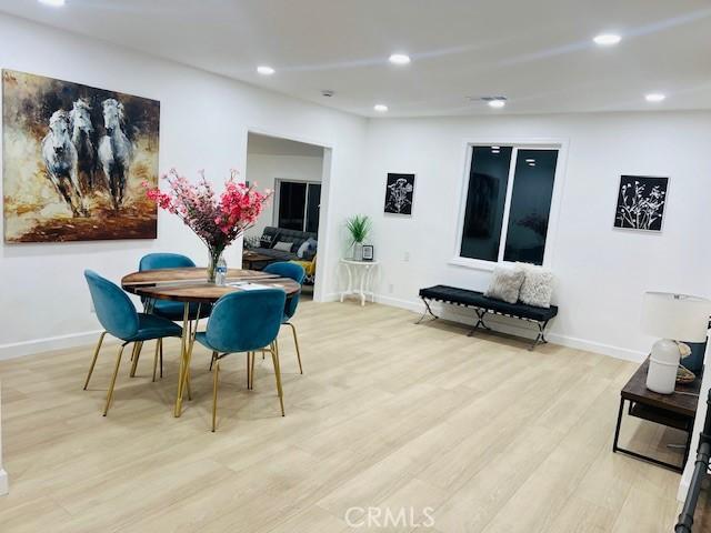 dining space with light hardwood / wood-style floors