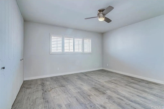 empty room featuring ceiling fan and light hardwood / wood-style floors