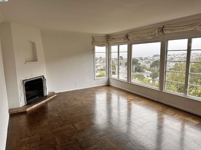 unfurnished living room featuring dark parquet floors