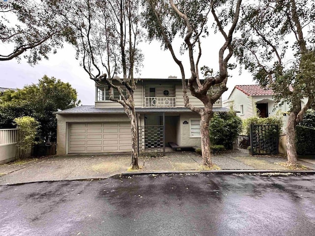 view of front of home with a garage and a balcony