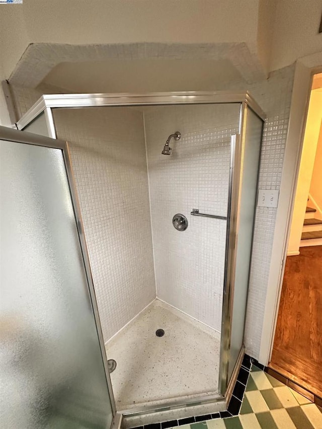 bathroom with a shower with shower door