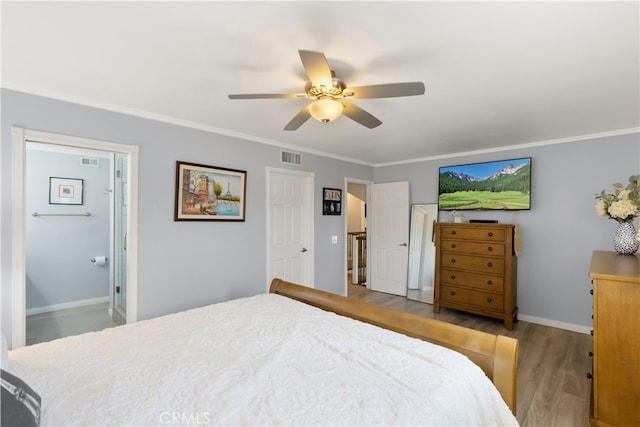 bedroom with crown molding, ceiling fan, light wood-type flooring, and ensuite bath