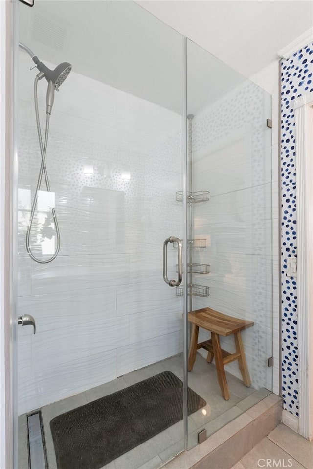 bathroom featuring tile patterned flooring and a shower with door