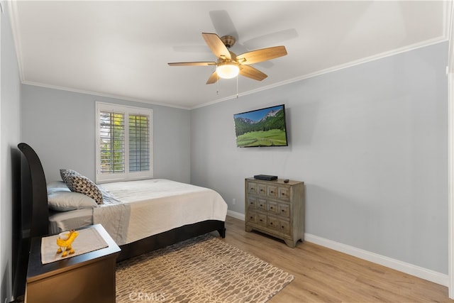 bedroom featuring ornamental molding, ceiling fan, and light hardwood / wood-style flooring