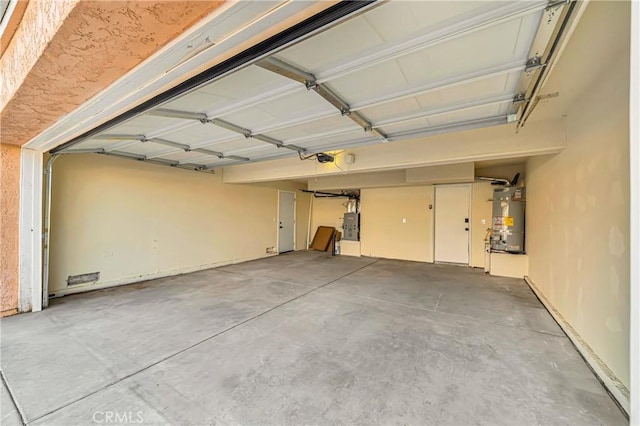 garage featuring a garage door opener, electric panel, and secured water heater