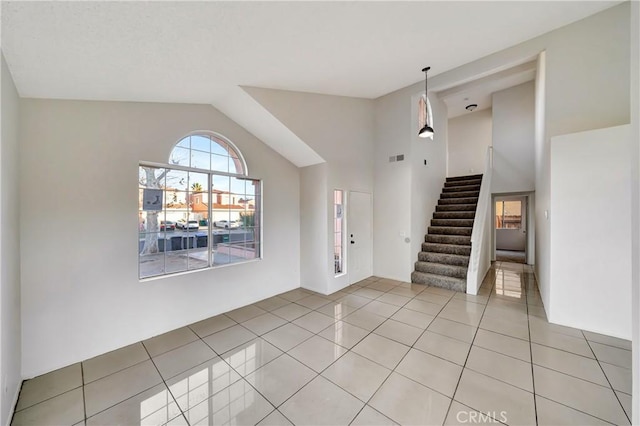 foyer featuring lofted ceiling and light tile patterned flooring