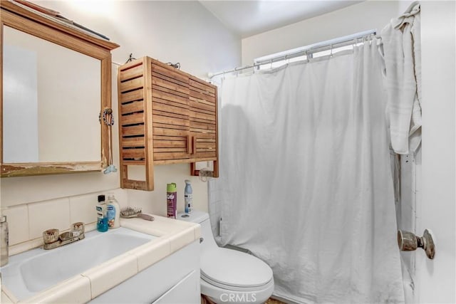 bathroom featuring vanity, a shower with curtain, and toilet