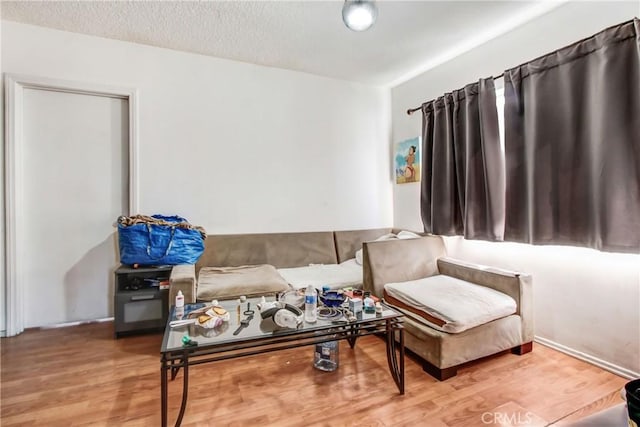 sitting room with hardwood / wood-style floors and a textured ceiling