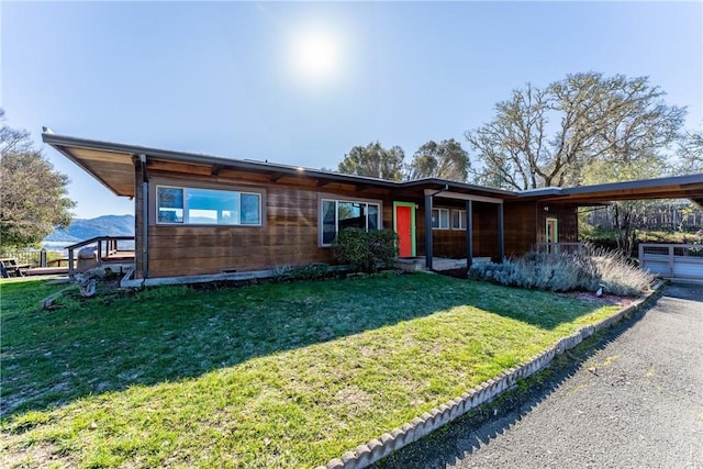 ranch-style house with a front lawn and a carport