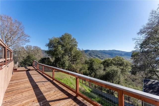 wooden deck with a mountain view