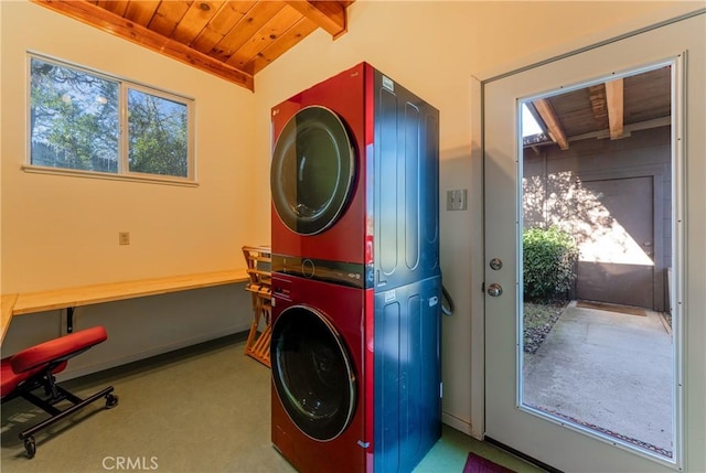 laundry area featuring stacked washer / dryer, wooden ceiling, and a healthy amount of sunlight