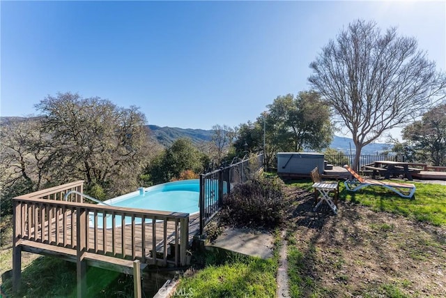 view of pool featuring a mountain view and a hot tub