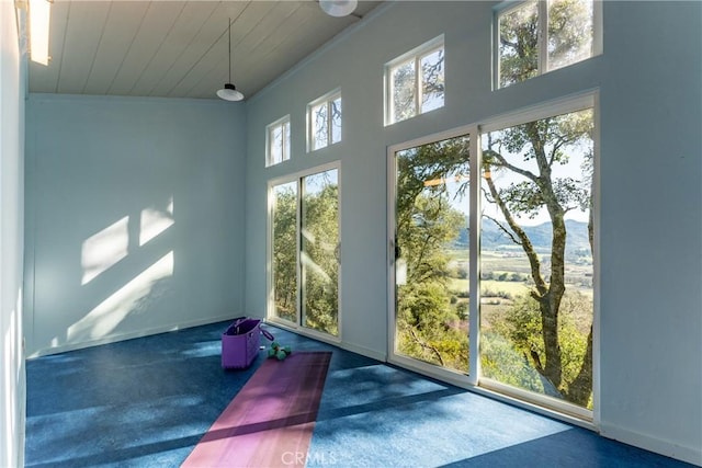 doorway with a mountain view and wooden ceiling