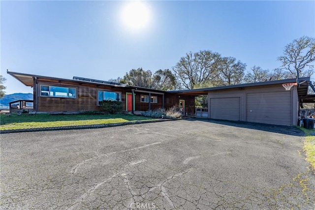 ranch-style house with a garage and a carport