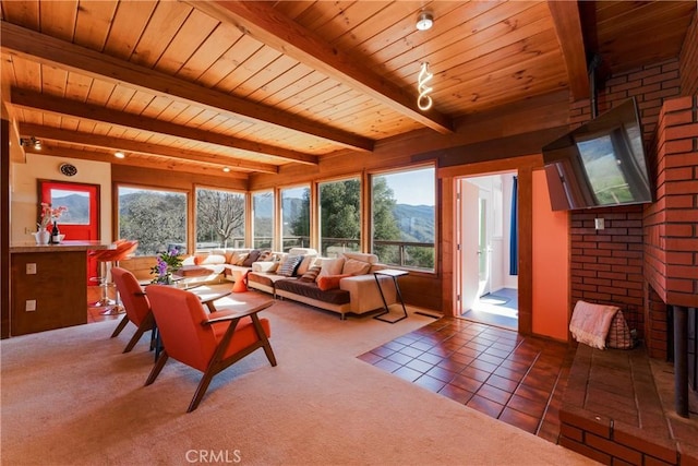 living room with tile patterned flooring, wooden ceiling, and beamed ceiling