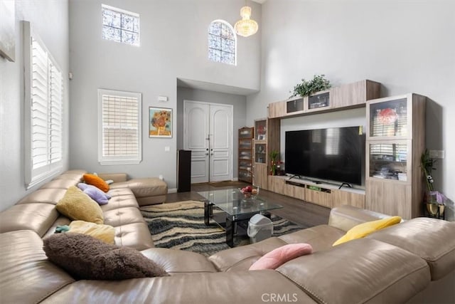 living room featuring hardwood / wood-style flooring and a towering ceiling