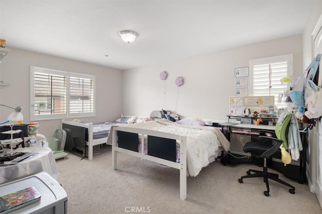 carpeted bedroom with multiple windows