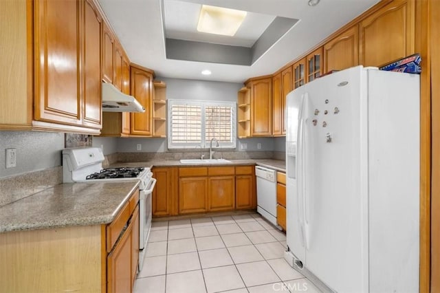 kitchen featuring white appliances, a raised ceiling, sink, and light tile patterned floors