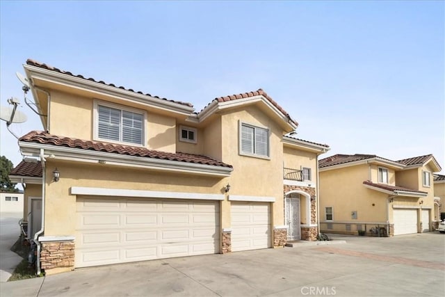 mediterranean / spanish home with a garage