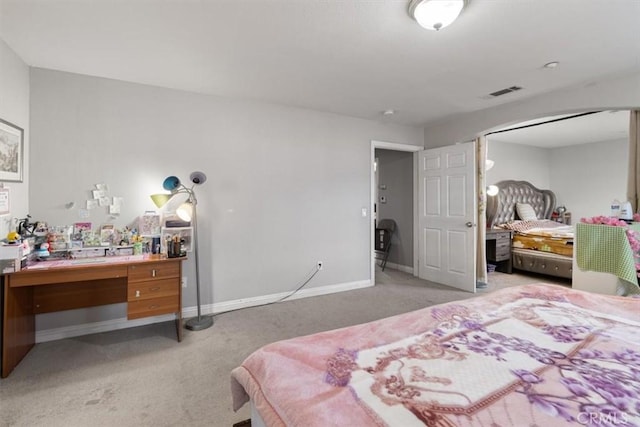 carpeted bedroom with a workshop area