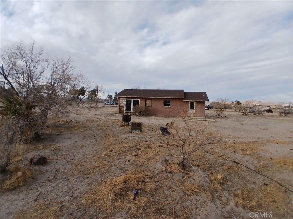 back of house with a rural view