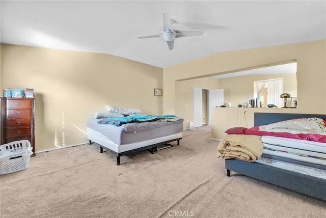 bedroom with vaulted ceiling, ceiling fan, and carpet flooring