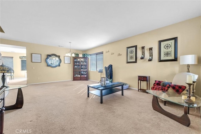 living room with an inviting chandelier and light colored carpet