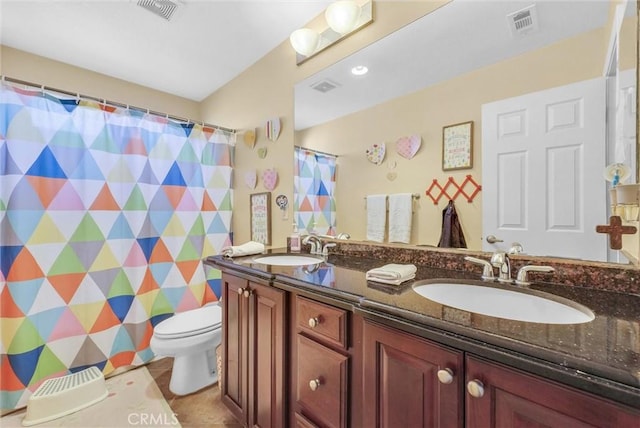 bathroom with vanity, tile patterned floors, and toilet