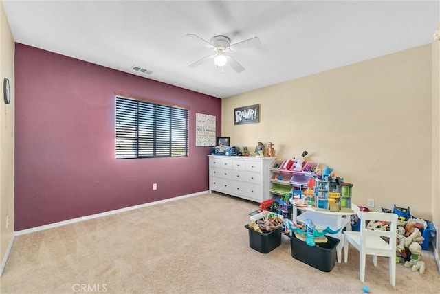 recreation room with light colored carpet and ceiling fan