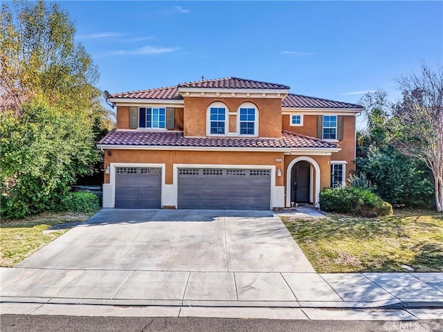 mediterranean / spanish-style home with a garage