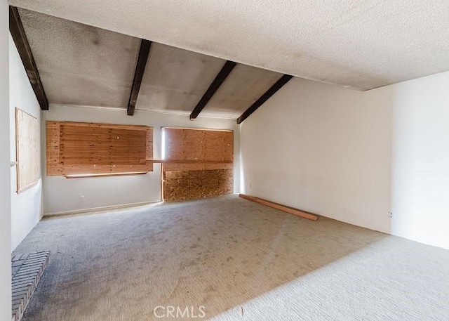 unfurnished living room featuring a textured ceiling, vaulted ceiling with beams, and carpet flooring