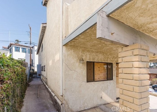 view of side of home featuring stucco siding