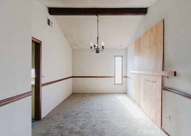 unfurnished dining area with vaulted ceiling with beams, a notable chandelier, carpet floors, and a textured ceiling