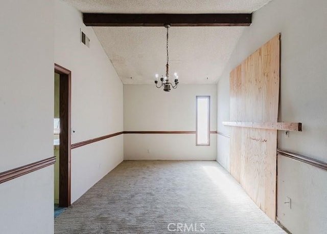 unfurnished room with a notable chandelier, carpet flooring, a textured ceiling, and lofted ceiling with beams