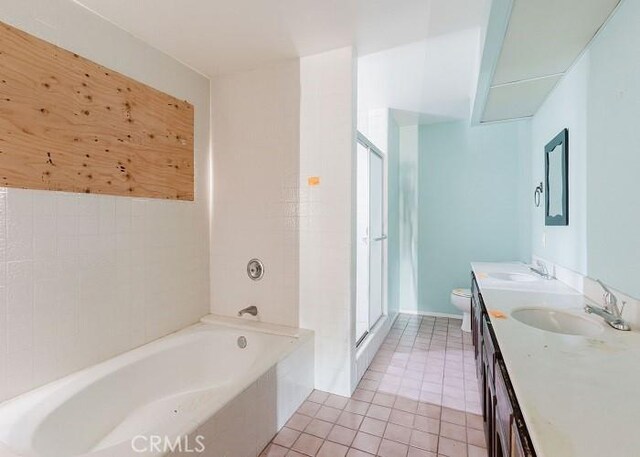 full bathroom featuring vanity, tile patterned flooring, toilet, and separate shower and tub