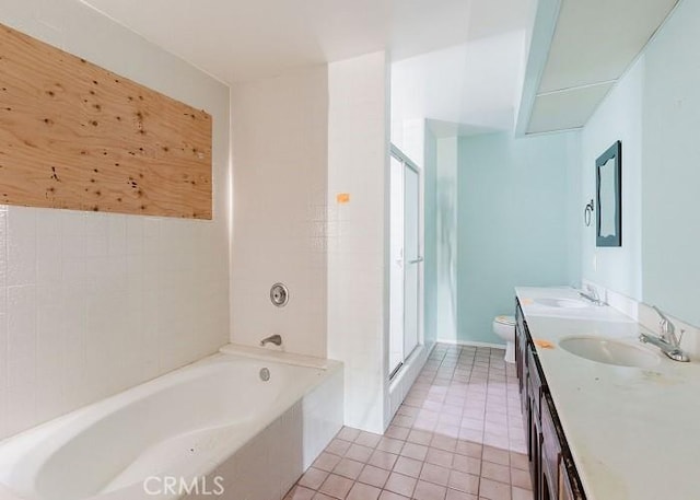 full bath with double vanity, a sink, tile patterned flooring, a shower stall, and a bath