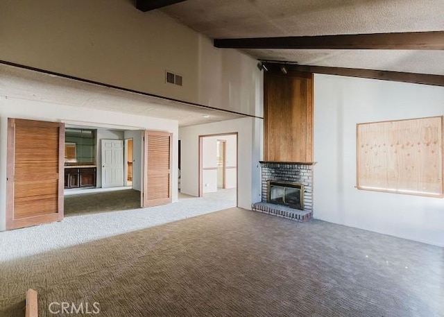 unfurnished living room featuring beamed ceiling, high vaulted ceiling, carpet flooring, and a fireplace