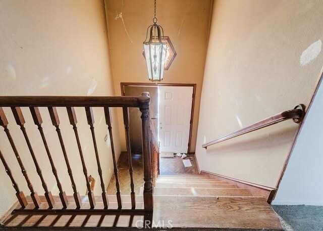 staircase with hardwood / wood-style floors