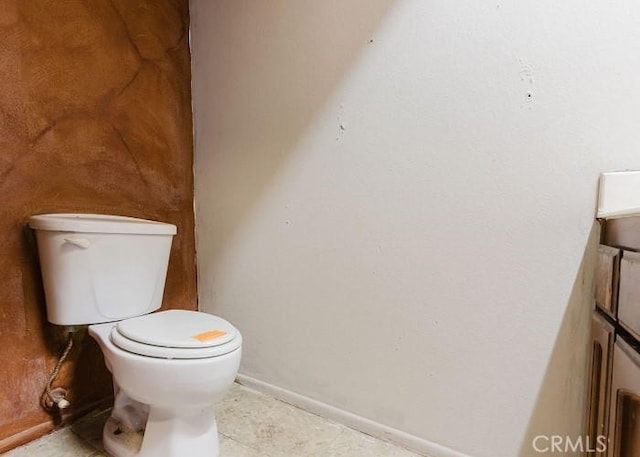 bathroom featuring tile patterned floors, toilet, and baseboards