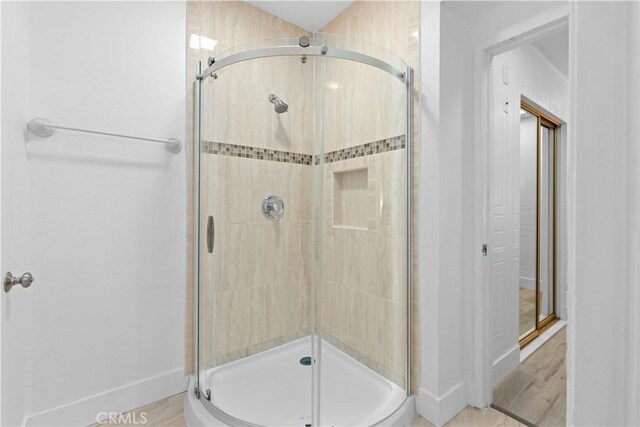 bathroom featuring a shower with door