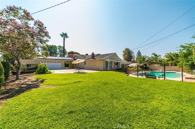 view of yard with a garage and a patio area