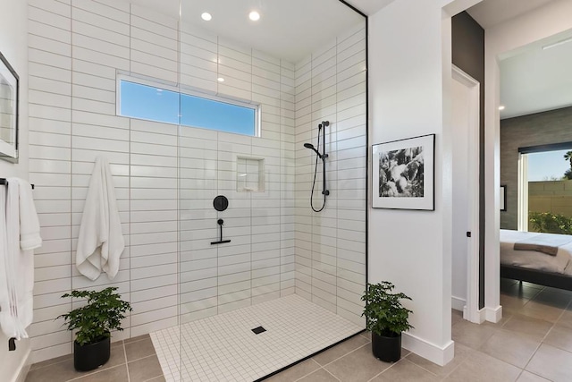 bathroom featuring a tile shower and tile patterned floors