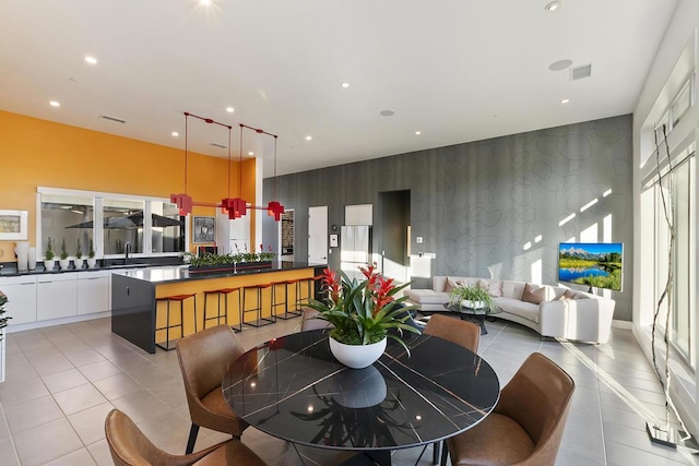 tiled dining room featuring sink