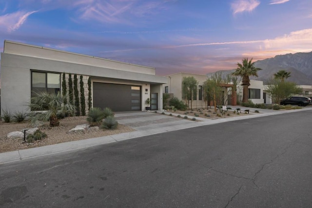 view of front of home with a garage and a mountain view