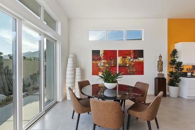 dining room with light tile patterned floors and a mountain view