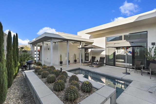 back of house with a fenced in pool and a patio area