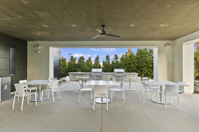 view of patio / terrace featuring grilling area, ceiling fan, and an outdoor kitchen