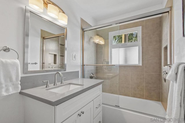 bathroom featuring vanity and combined bath / shower with glass door