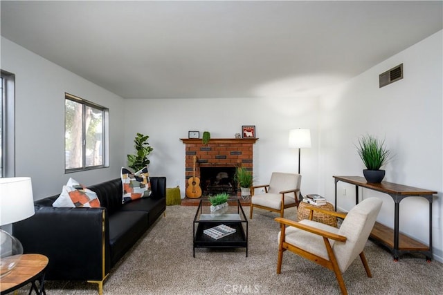 carpeted living room featuring a brick fireplace